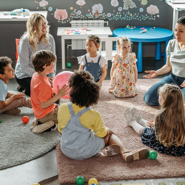 group of children who are different learners sitting in a circle in the classroom